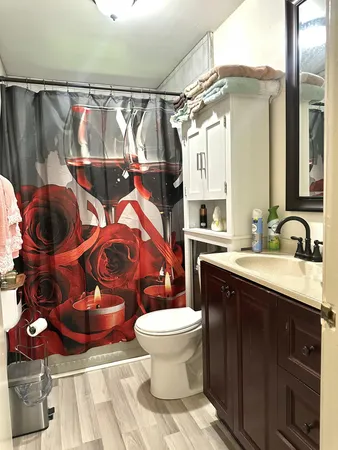 a spacious bedroom with a bed a table and large windows