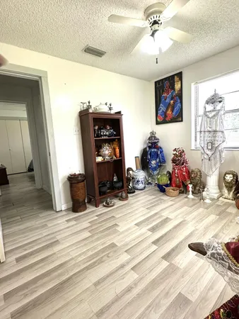 a bedroom with a bed and a ceiling fan