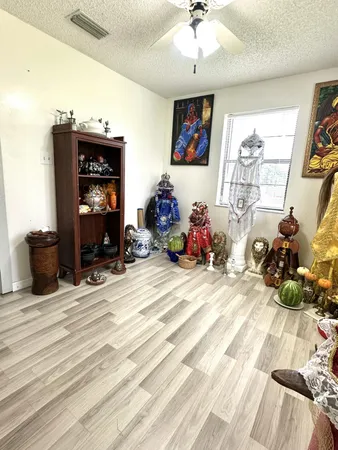 a living room with furniture and a lamp