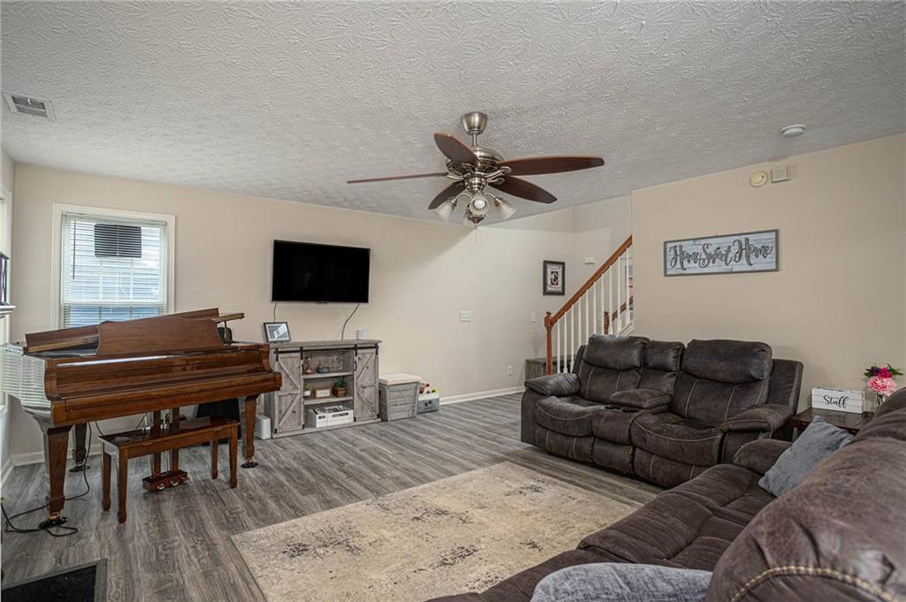 3954 Riverside Parkway Decatur, GA 30034 - Photo 11 of 38 a living room with furniture and a flat screen tv with wooden floor