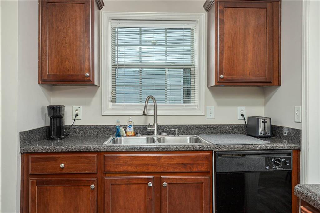 3954 Riverside Parkway Decatur, GA 30034 - Photo 20 of 38 a kitchen with granite countertop stainless steel appliances sink refrigerator and cabinets