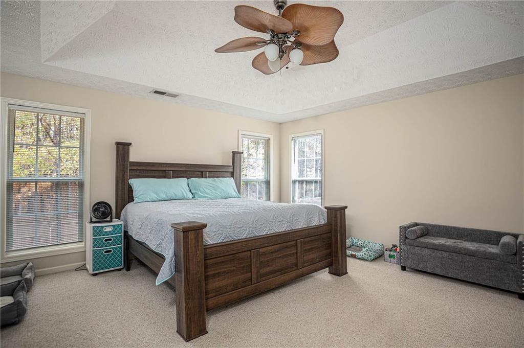 3954 Riverside Parkway Decatur, GA 30034 - Photo 23 of 38 a bedroom with a bed and a chandelier fan