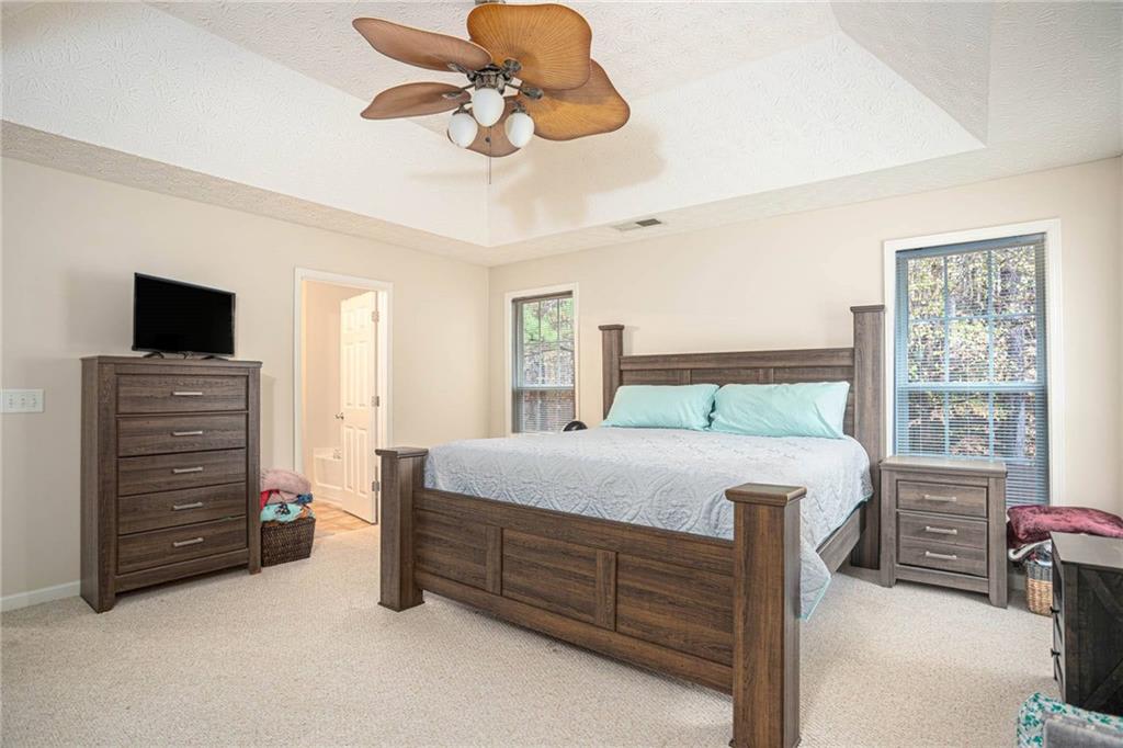 3954 Riverside Parkway Decatur, GA 30034 - Photo 24 of 38 a bedroom with a bed and a chandelier