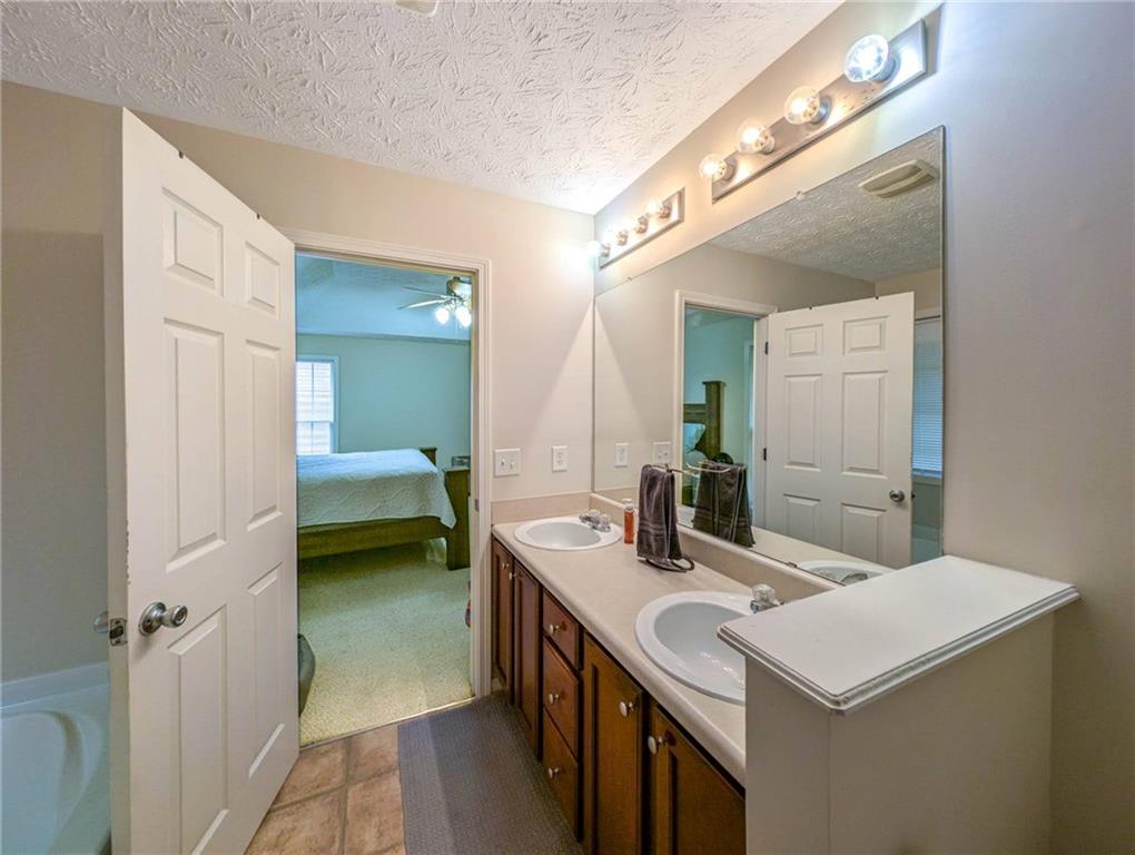 3954 Riverside Parkway Decatur, GA 30034 - Photo 27 of 38 a en suite bathroom with a sink and a mirror