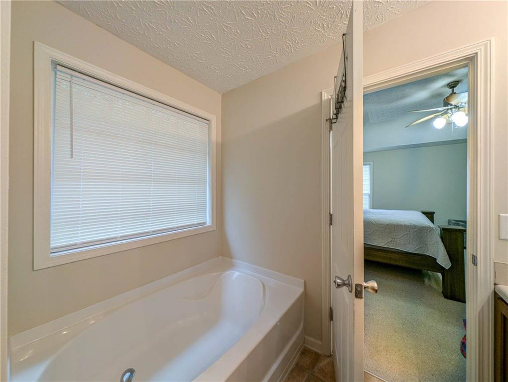 3954 Riverside Parkway Decatur, GA 30034 - Photo 28 of 38 a en suite bathroom with a tub and shower
