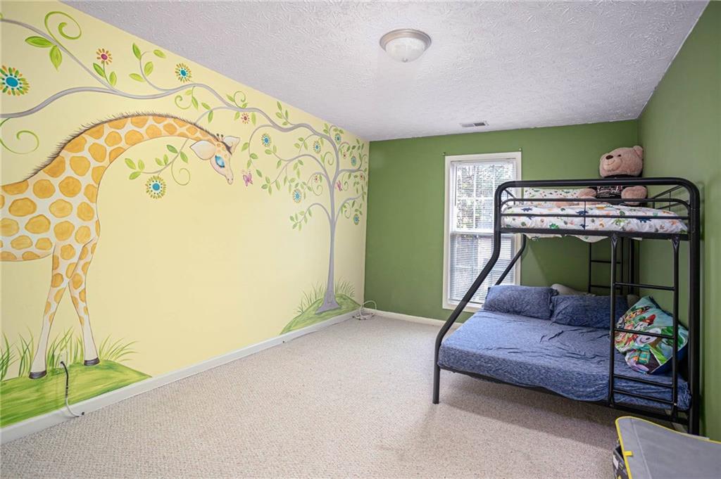 3954 Riverside Parkway Decatur, GA 30034 - Photo 29 of 38 a bedroom with a bed and a table in it