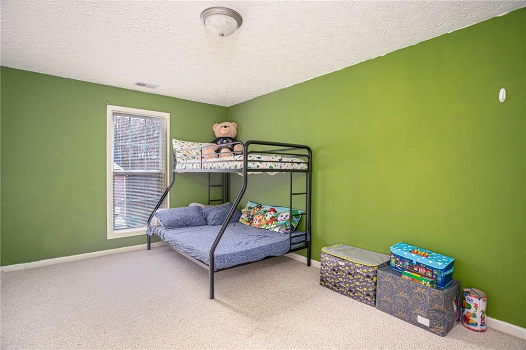 3954 Riverside Parkway Decatur, GA 30034 - Photo 30 of 38 a bedroom with a bed and a couch