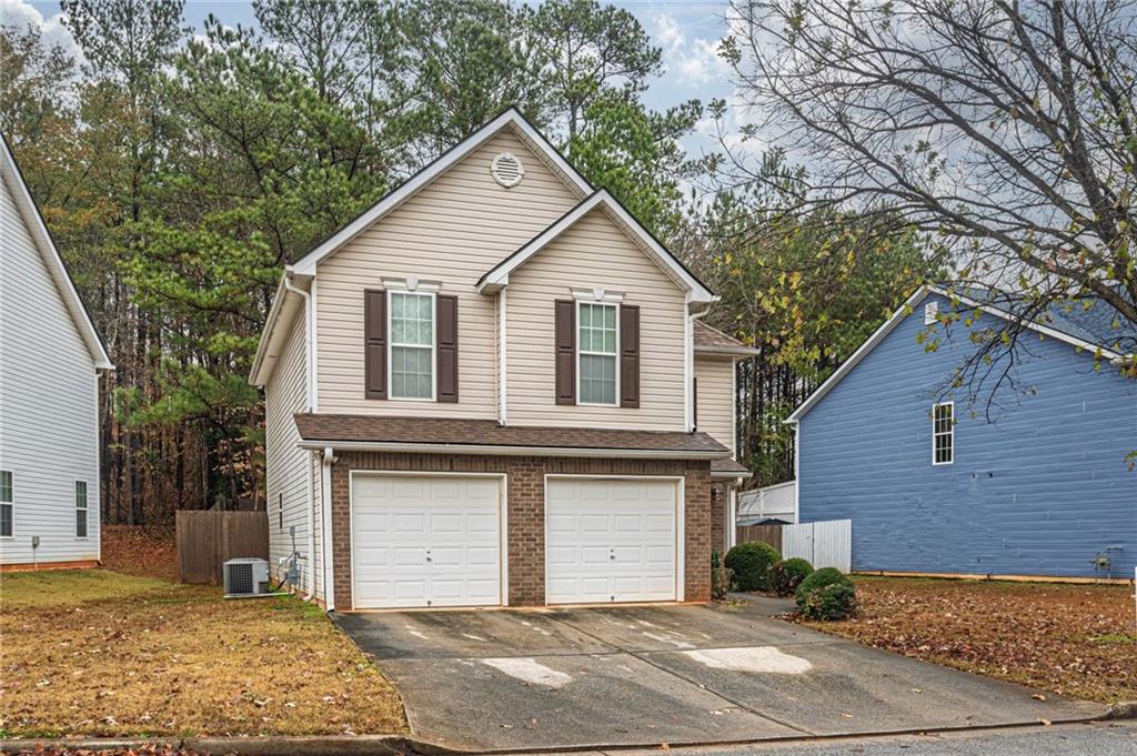 3954 Riverside Parkway Decatur, GA 30034 - Photo 3 of 38 a front view of a house with a yard and garage