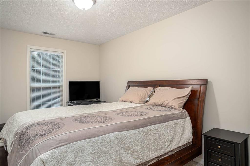 3954 Riverside Parkway Decatur, GA 30034 - Photo 32 of 38 a bedroom with a bed and a tv