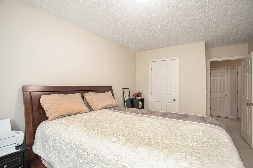 3954 Riverside Parkway Decatur, GA 30034 - Photo 33 of 38 a large bed sitting in a bedroom and a lamp