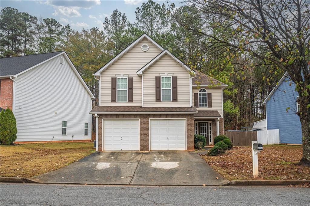 3954 Riverside Parkway Decatur, GA 30034 - Photo 5 of 38 a front view of a house with a yard and garage