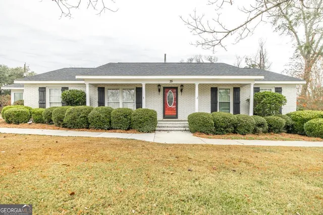 a front view of house with yard and green space