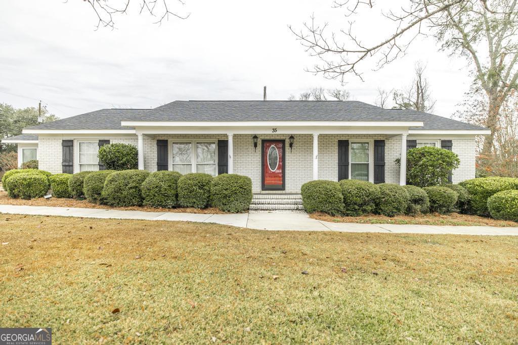 35 Commerce Street Alamo, GA 30411 - Photo 1 of 37 a front view of house with yard and green space
