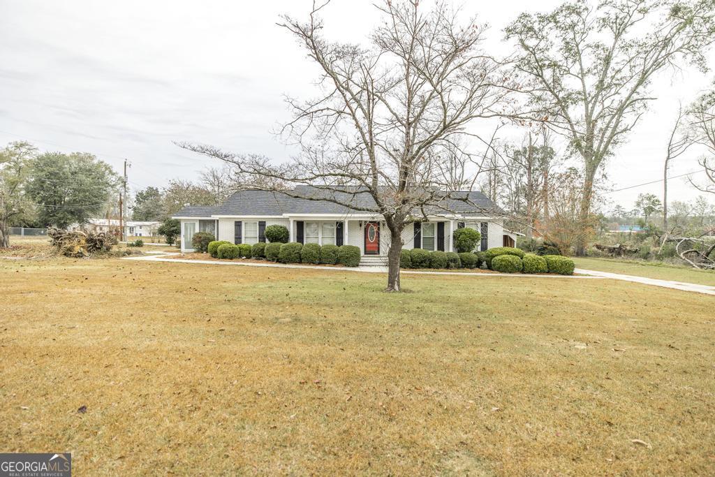 35 Commerce Street Alamo, GA 30411 - Photo 11 of 37 a front view of house with yard