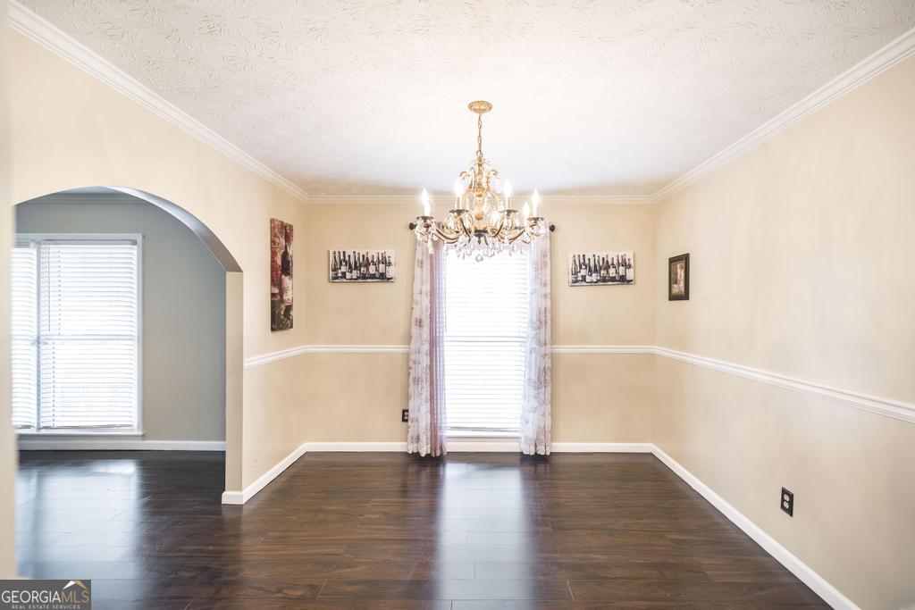 35 Commerce Street Alamo, GA 30411 - Photo 18 of 37 a view of a hallway with wooden floor and a chandelier