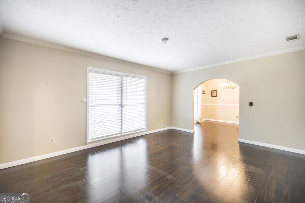 35 Commerce Street Alamo, GA 30411 - Photo 19 of 37 an empty room with wooden floor and windows