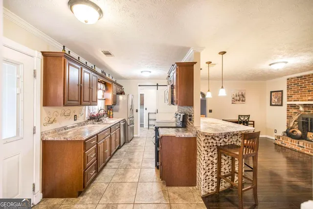 a large kitchen with kitchen island granite countertop a large counter top and appliances