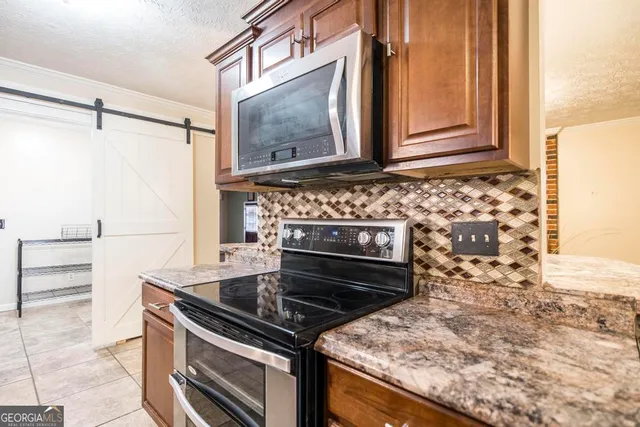 a stove top oven sitting inside of a kitchen