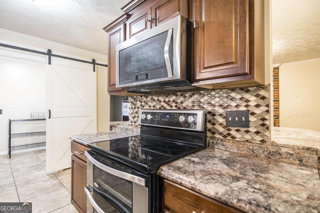 35 Commerce Street Alamo, GA 30411 - Photo 21 of 37 a stove top oven sitting inside of a kitchen