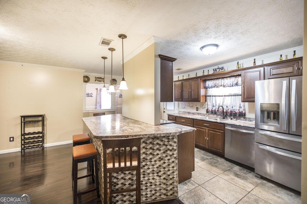 35 Commerce Street Alamo, GA 30411 - Photo 23 of 37 a kitchen with granite countertop a sink and refrigerator