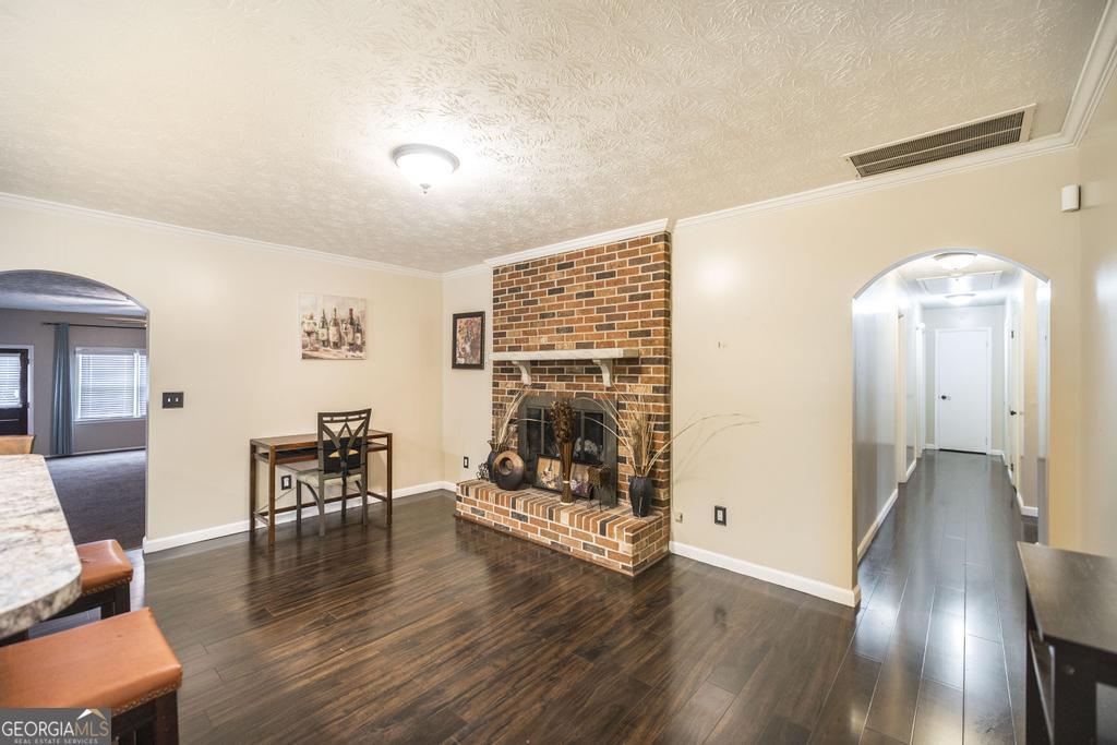 35 Commerce Street Alamo, GA 30411 - Photo 24 of 37 a dining room with furniture wooden floor a rug and a chandelier
