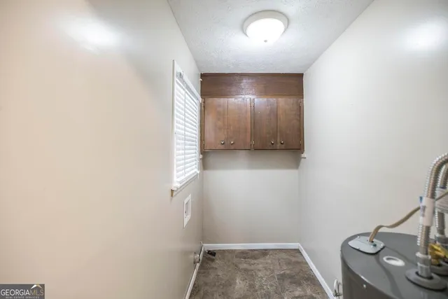 a view of a livingroom with a chandelier furniture and a ceiling fan