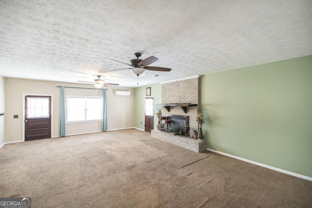 35 Commerce Street Alamo, GA 30411 - Photo 28 of 37 a view of a livingroom with a chandelier furniture and a ceiling fan