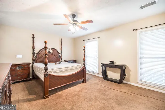 an empty room with toys and ceiling fan