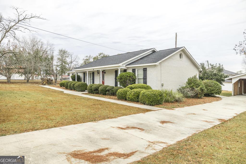 35 Commerce Street Alamo, GA 30411 - Photo 3 of 37 a view of house with yard and swimming pool