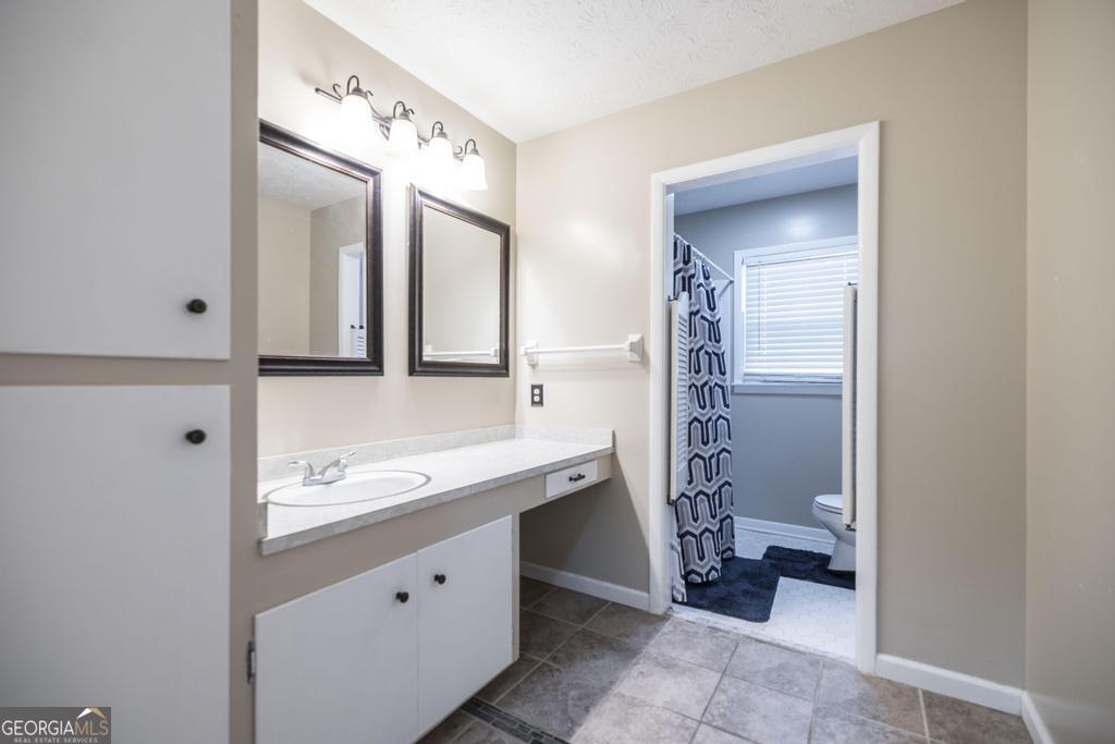 35 Commerce Street Alamo, GA 30411 - Photo 36 of 37 a bathroom with a double vanity sink mirror and