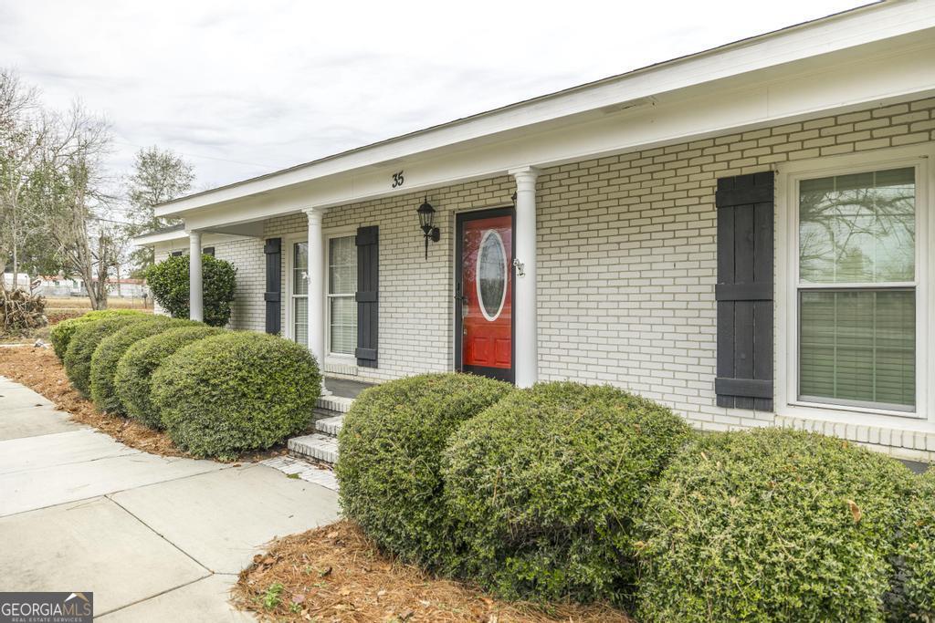 35 Commerce Street Alamo, GA 30411 - Photo 4 of 37 a view of a house with a garden