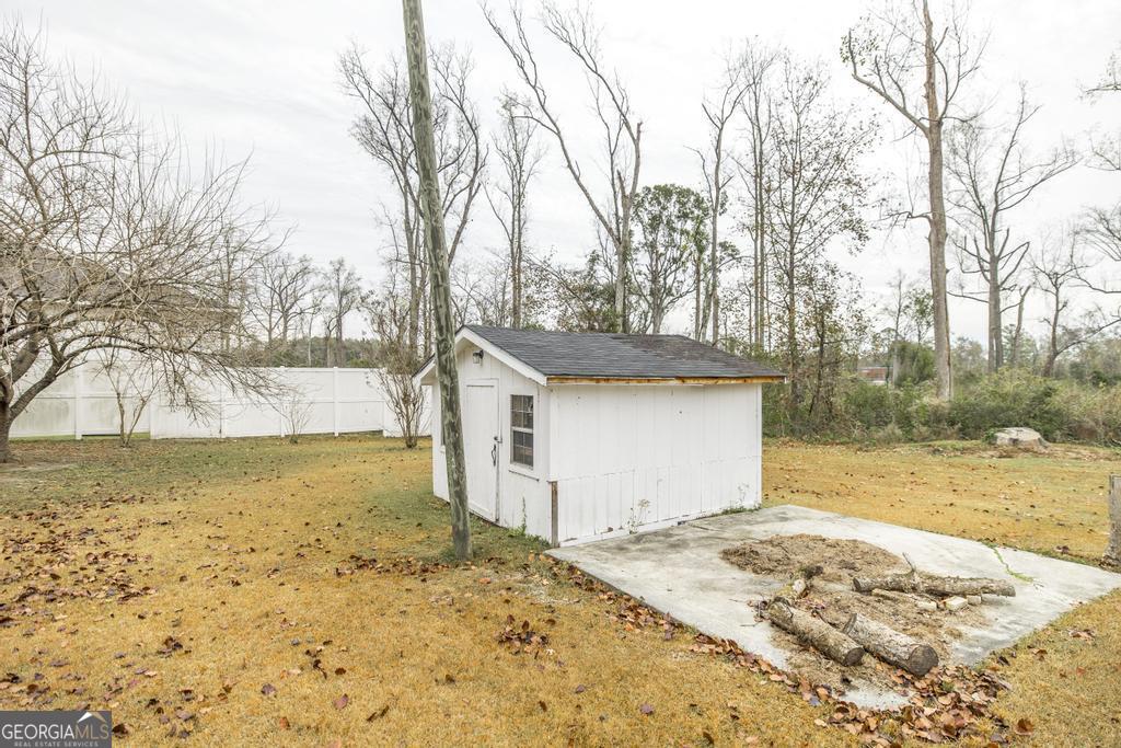 35 Commerce Street Alamo, GA 30411 - Photo 5 of 37 a view of a yard with snow on the road