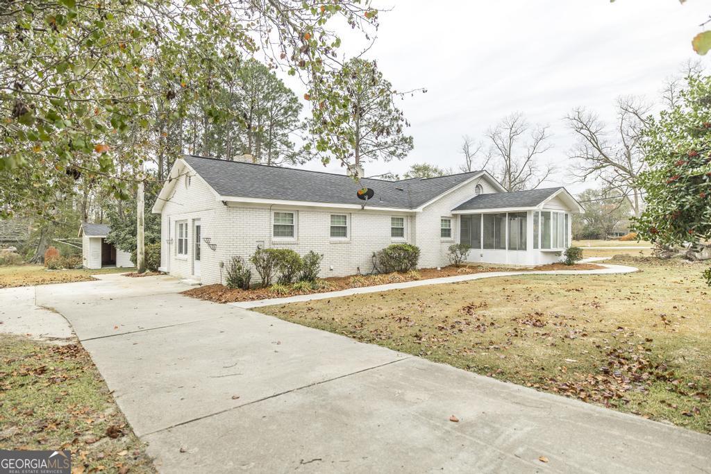 35 Commerce Street Alamo, GA 30411 - Photo 6 of 37 front view of a house with a yard