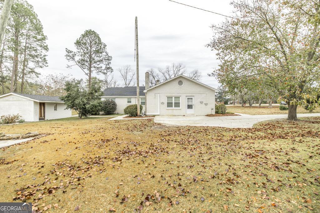 35 Commerce Street Alamo, GA 30411 - Photo 7 of 37 a view of white house with a yard