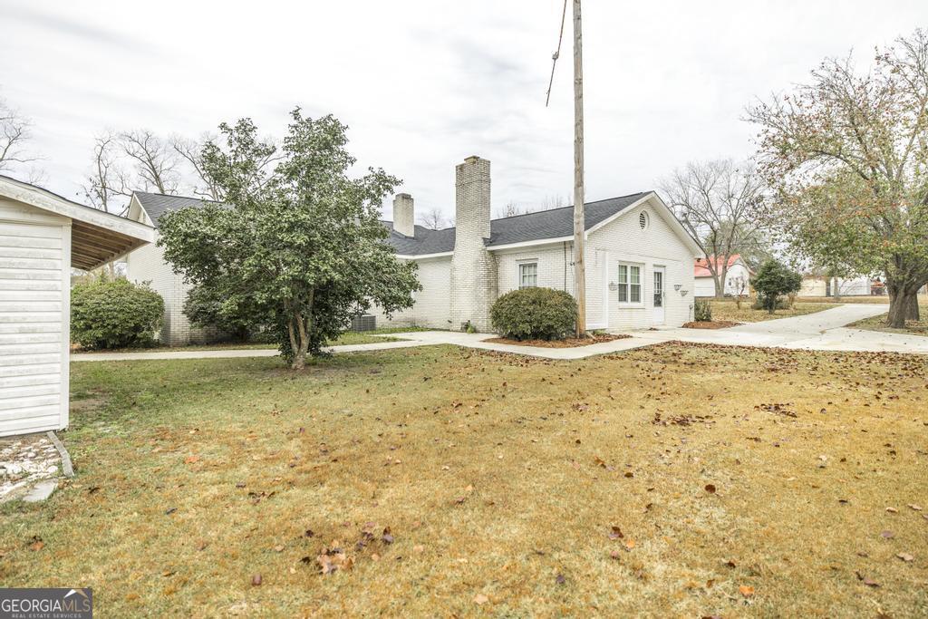 35 Commerce Street Alamo, GA 30411 - Photo 8 of 37 a view of a house with a yard