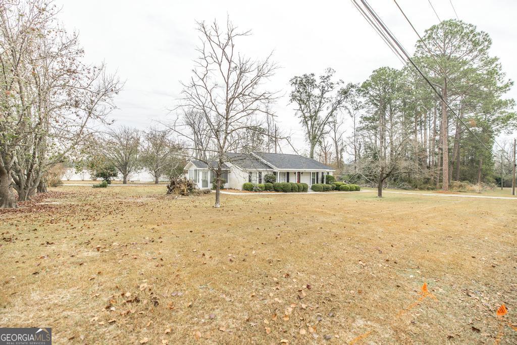 35 Commerce Street Alamo, GA 30411 - Photo 10 of 37 a view of road covered with snow