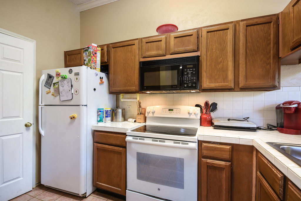 2802 Nueces Street, Unit 312 Austin, TX 78705 - Photo 11 of 22 a kitchen with stainless steel appliances a stove microwave and refrigerator