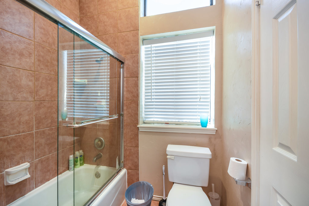 2802 Nueces Street, Unit 312 Austin, TX 78705 - Photo 15 of 22 a bathroom with a toilet a sink and bathtub