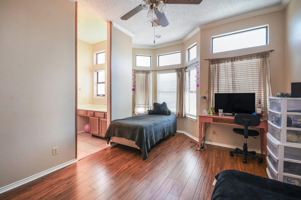 2802 Nueces Street, Unit 312 Austin, TX 78705 - Photo 17 of 22 a bedroom with furniture and a flat screen tv