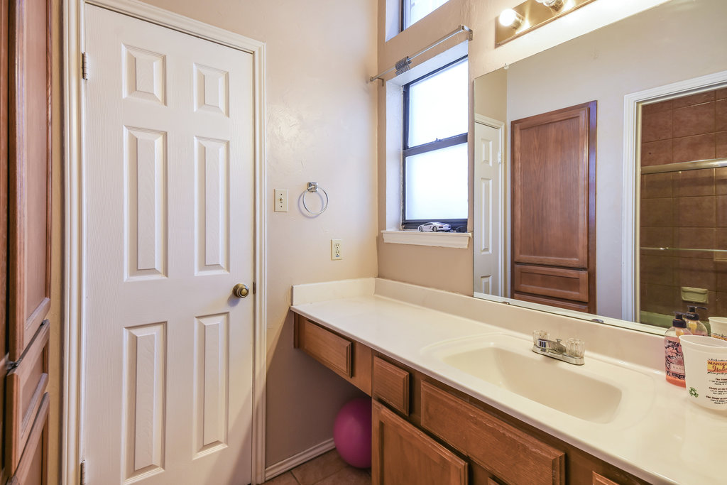 2802 Nueces Street, Unit 312 Austin, TX 78705 - Photo 18 of 22 a bathroom with a sink and a mirror