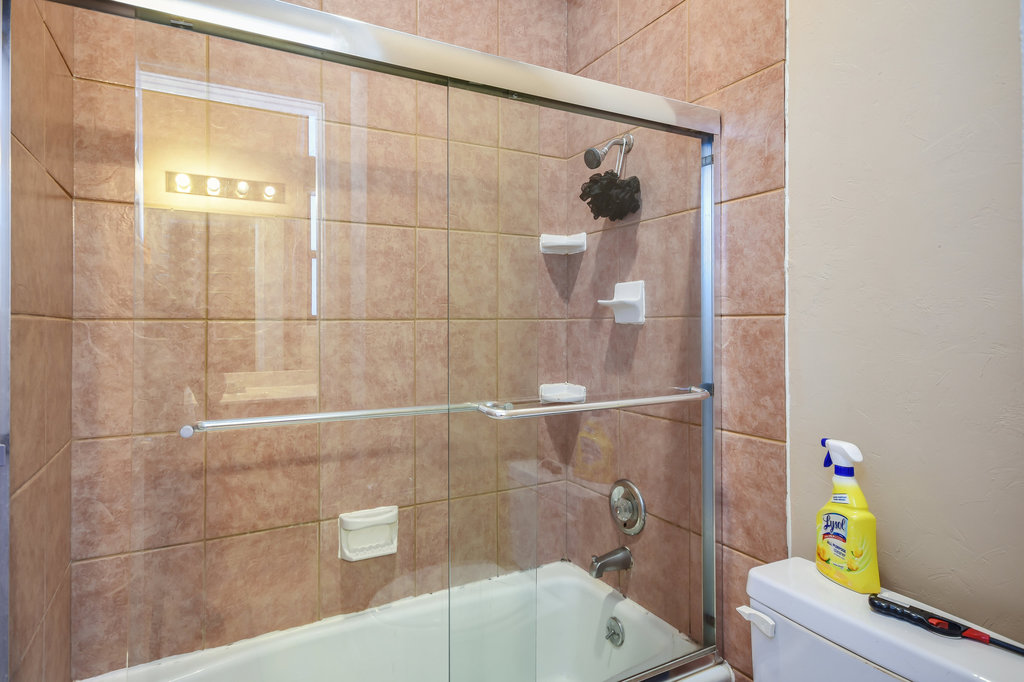 2802 Nueces Street, Unit 312 Austin, TX 78705 - Photo 19 of 22 a bathroom with a bathtub and shower