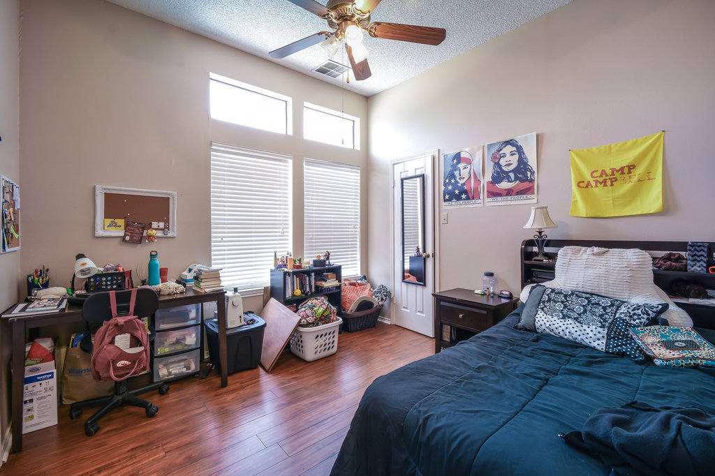 2802 Nueces Street, Unit 312 Austin, TX 78705 - Photo 21 of 22 a bedroom with bed and wooden floor