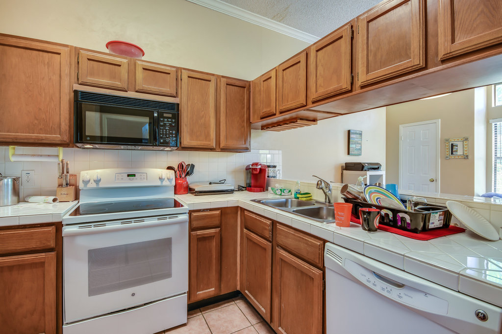 2802 Nueces Street, Unit 312 Austin, TX 78705 - Photo 10 of 22 a kitchen with cabinets stainless steel appliances and a sink