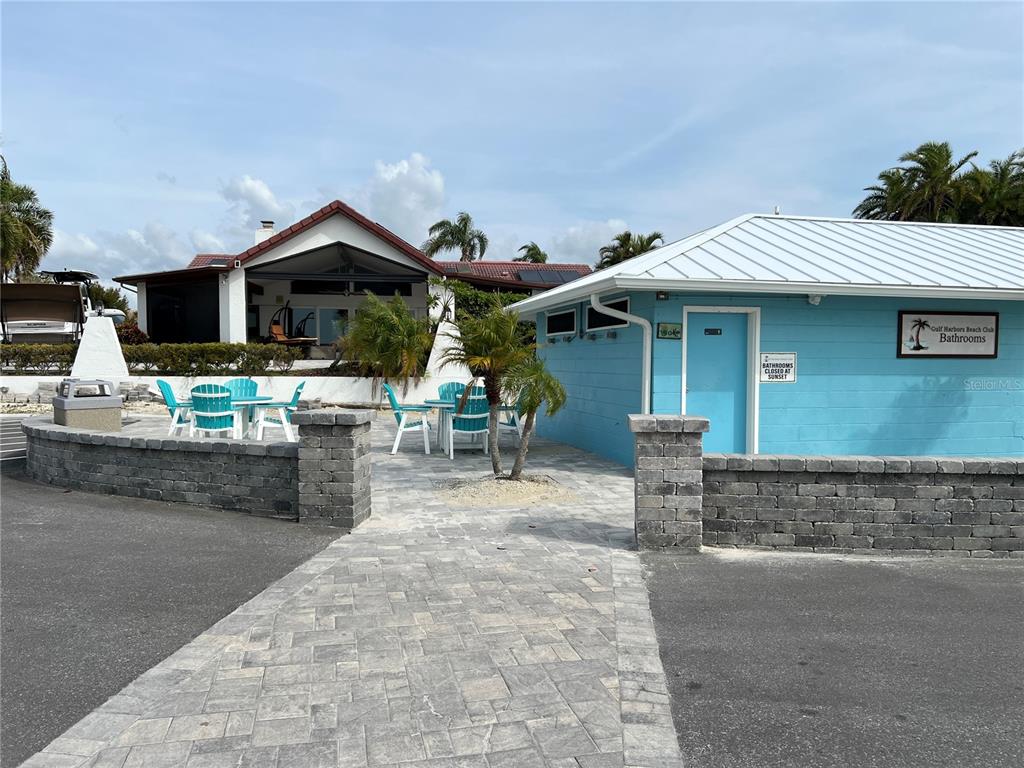 4726 Marine Parkway, Unit 104 New Port Richey, FL 34652 - Photo 15 of 19 a front view of a house with garden