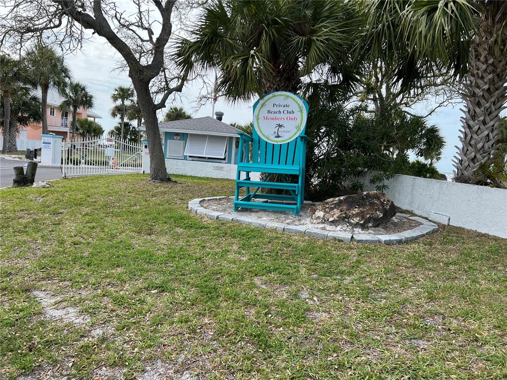 4726 Marine Parkway, Unit 104 New Port Richey, FL 34652 - Photo 4 of 19 a view of a garden with a bench and trees around
