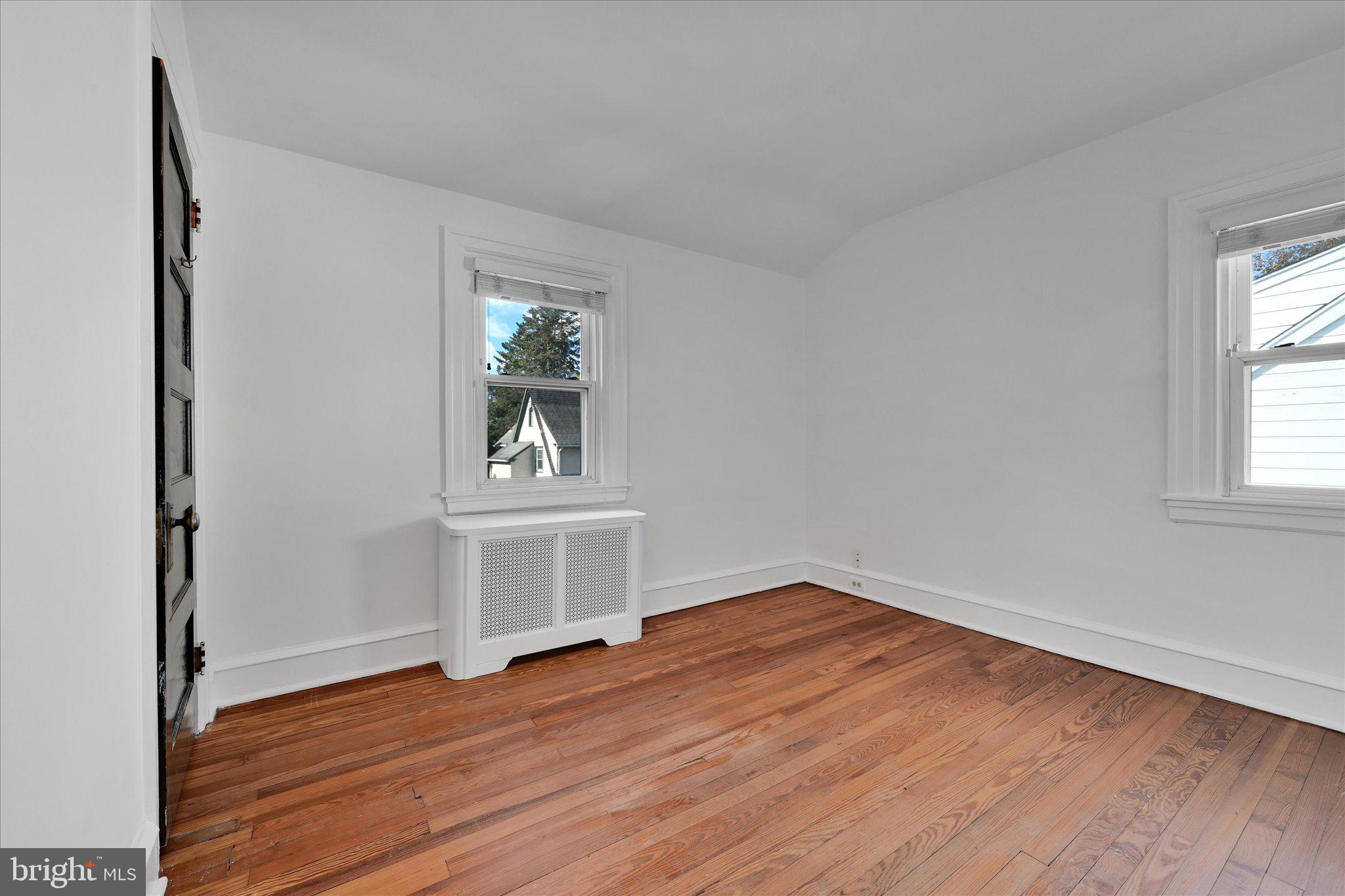 2814 St Marys Road Ardmore, PA 19003 - Photo 13 of 21 an empty room with wooden floor and windows