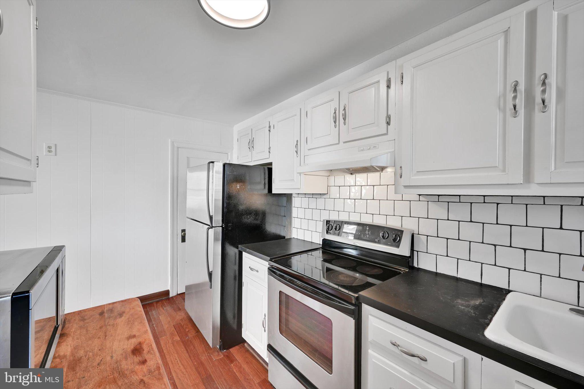 2814 St Marys Road Ardmore, PA 19003 - Photo 7 of 21 a kitchen with granite countertop a stove sink and refrigerator