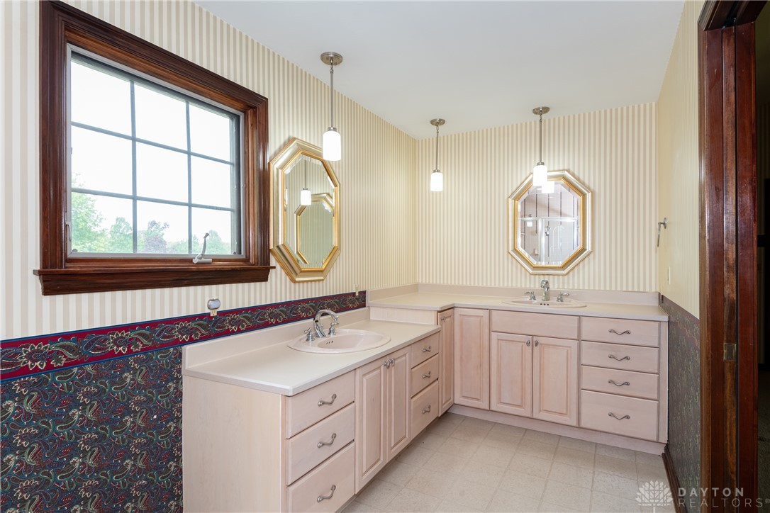 9981 Ridge Acres Lane Englewood, OH 45322 - Photo 38 of 73 This bathroom features dual vanities, providing ample counter space and storage.