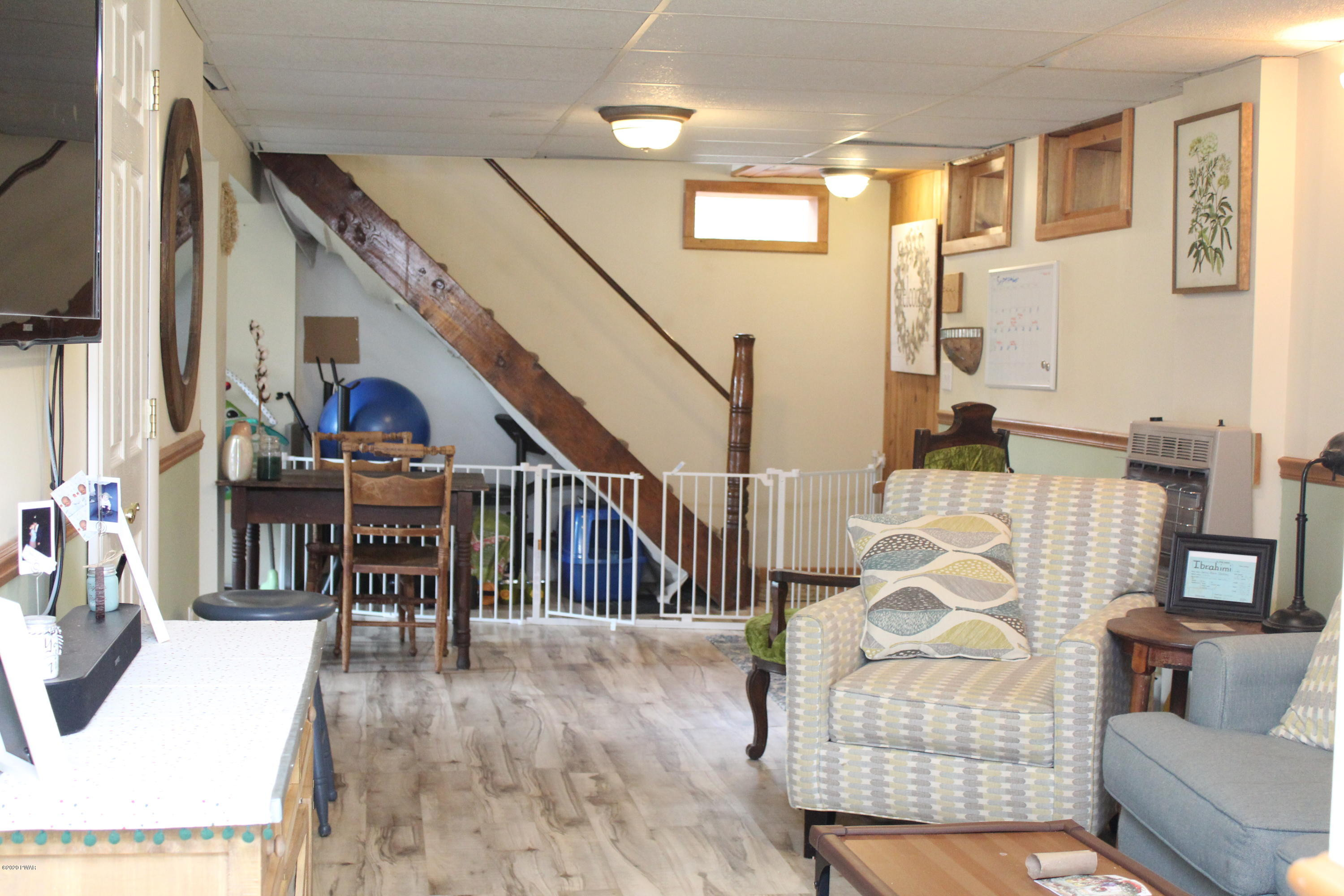 798 Goose Pond Road Lake Ariel, PA 18436 - Photo 32 of 47 a living room with furniture and a dining table with wooden floor