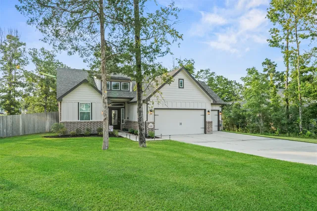 a front view of house with a yard and trees